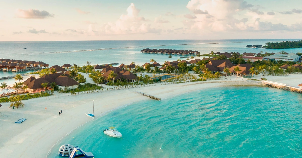 A stunning view of Maldives luxury travel resort over turquoise waters.